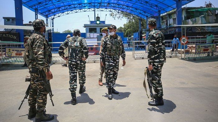 Security personnel stand guard outside Air Force Station after two low intensity explosions reported in the technical area of Jammu Air Force Station. Credit: PTI Photo