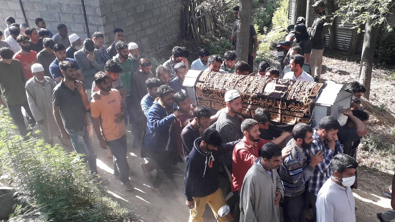 Villagers carry the coffin of daughter of a policeman who was killed along with her father and mother by suspected militants at Hariparigam area of Awantipora in Pulwama. Credit: PTI Photo