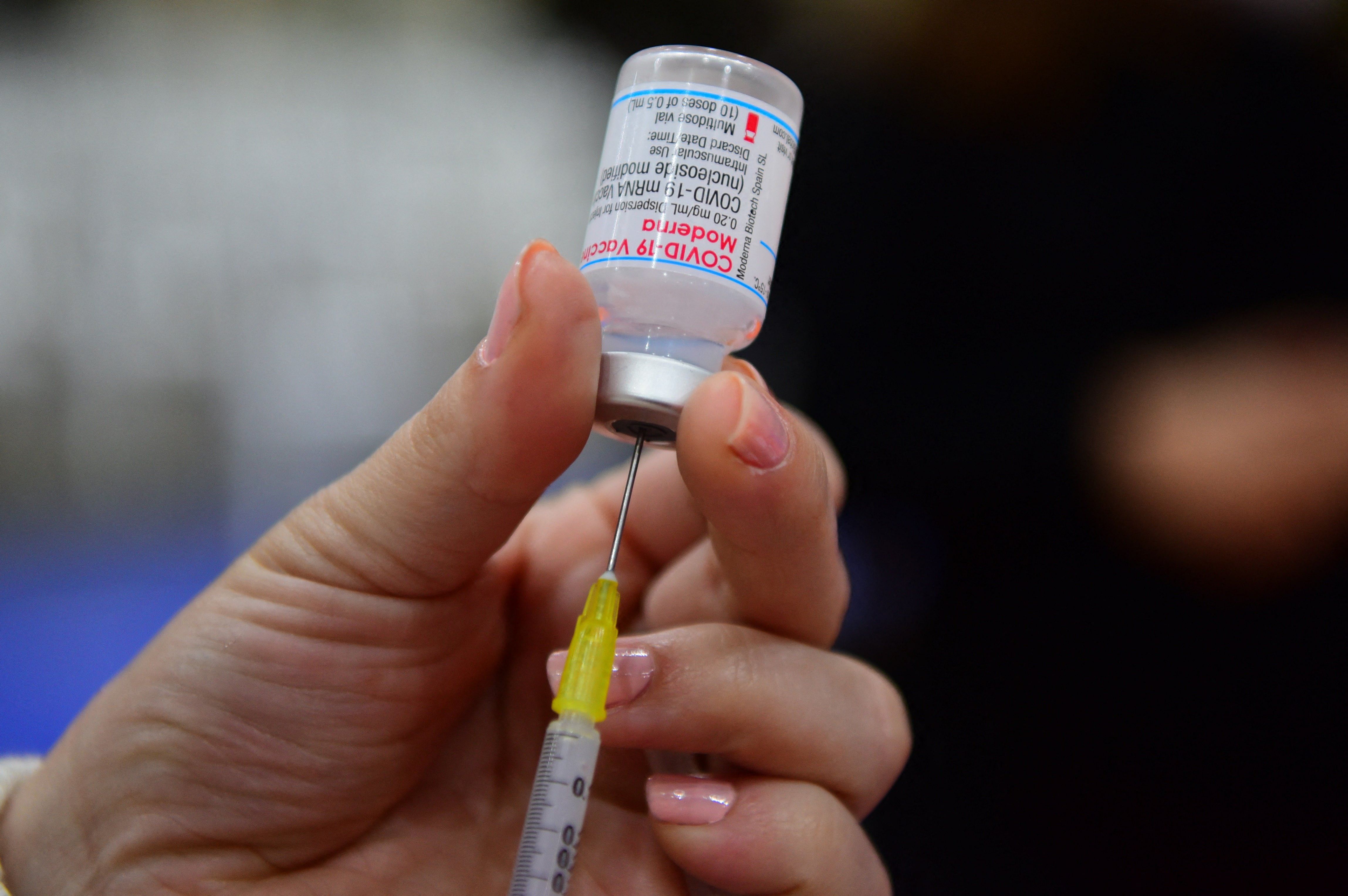 A health worker prepares a dose of the Moderna vaccine against Covid-19 at the National Secretary of Sports vaccination centre in Asuncion, Paraguay. Credit: AFP File Photo