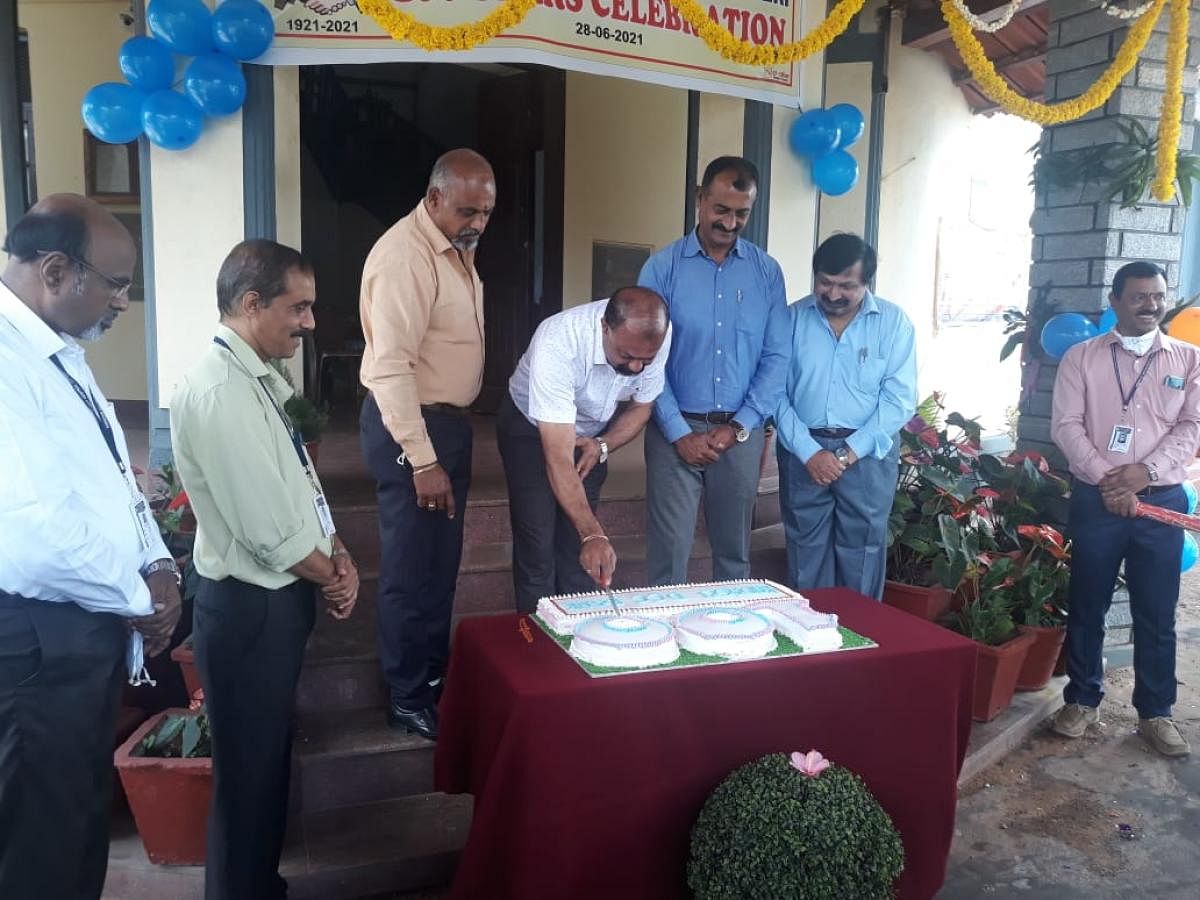 District Central Cooperative Bank president Kodandera P Ganapathy cuts a cake to mark the bank's centenary on Monday.