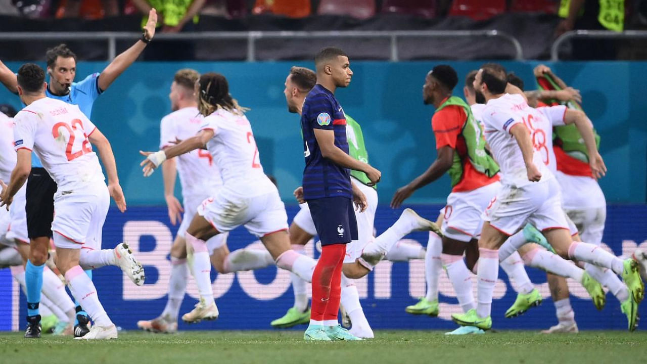 France's forward Kylian Mbappe (C) reacts after missing a penalty during the UEFA EURO 2020 round of 16 football match between France and Switzerland at the National Arena in Bucharest. Credit: AFP Photo