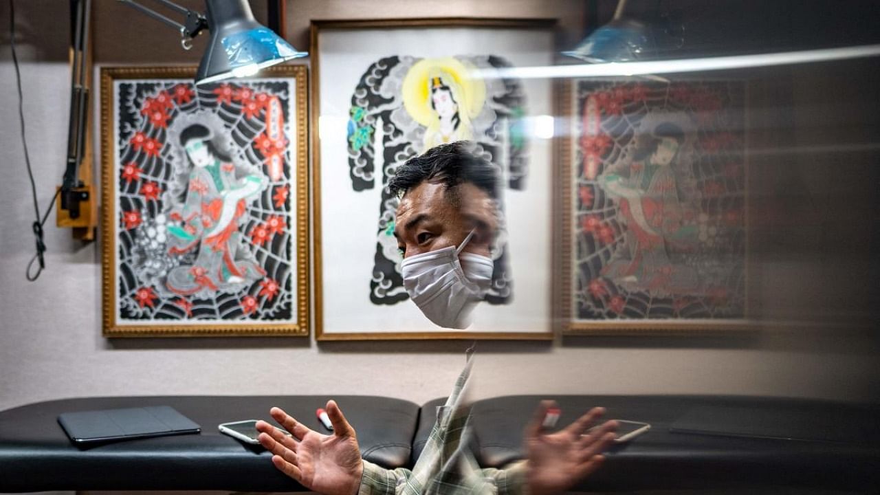 This picture taken on June 22, 2021 shows Japanese tattoo artist Ichi Hatano speaking during an interview with AFP at his studio in Tokyo. Credit: AFP Photo