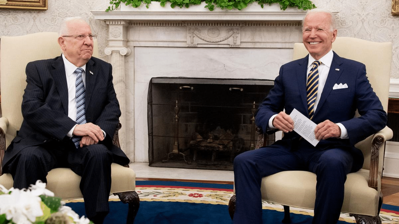 US President Joe Biden smiles during a meeting with Israeli President Reuven Rivlin (L) in the Oval Office of the White House in Washington. Credit: AFP Photo