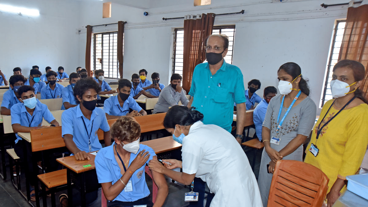 Students are vaccinated at a government first grade college in Mangaluru on Monday. Credit: DH Photo/Govindaraj Javali