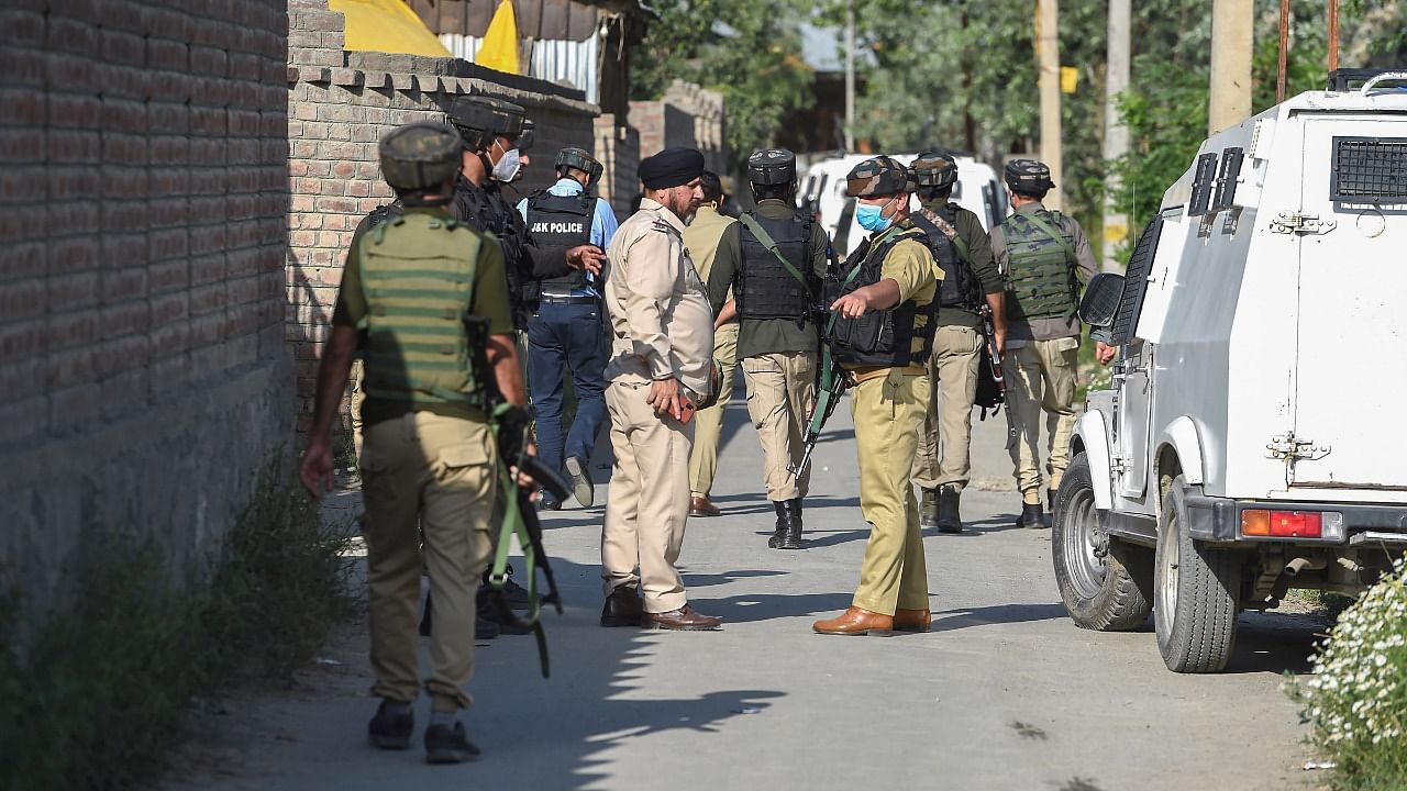 Security personnel during the ongoing encounter with militants, at Maloora on the outskirts of Srinagar. Credit: PTI Photo
