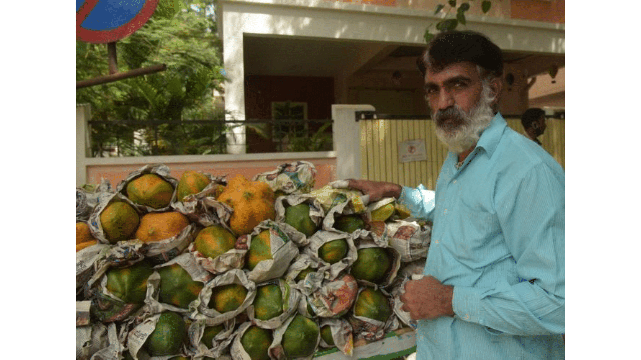 Left with no option, Satish, who drove children to school for 20 years, is now a fruit vendor. Credit: DH Photo/B H Shivakumar
