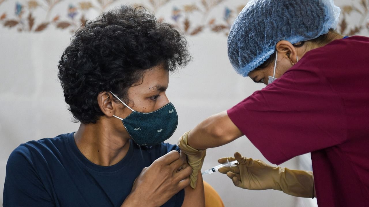 A Mumbai resident gets inoculated. Credit: AFP Photo