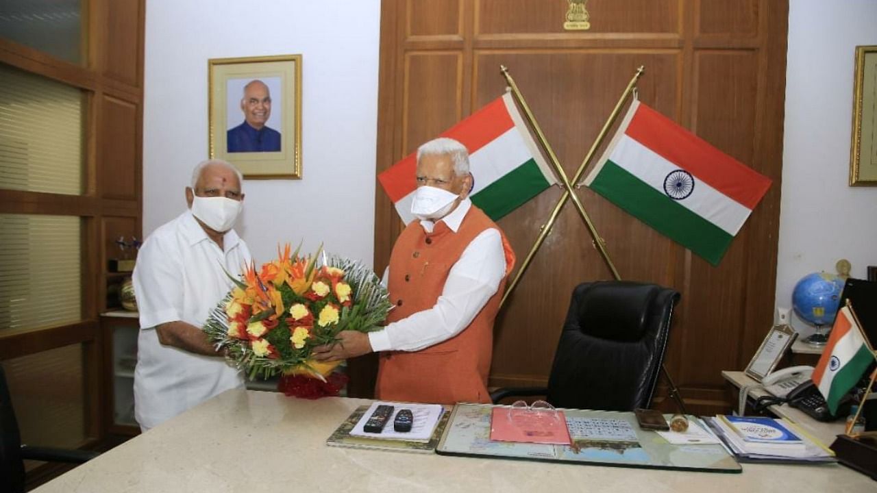 Karnataka CM B S Yediyurappa (left) with Governor Vajubhai Vala. Credit: Twitter/@bharathjoshi