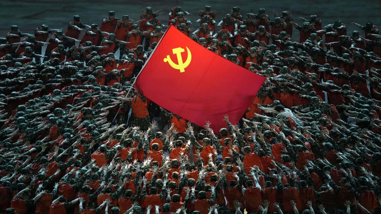 Performers dressed as rescue workers gather around the Communist Party flag during a gala show ahead of the 100th anniversary of the founding of the Chinese Communist Party in Beijing. Credit: AP Photo