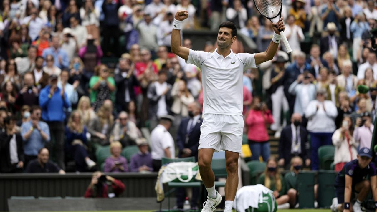 Serbia's Novak Djokovic celebrates winning the men's singles second round match against South Africa's Kevin Anderson on day three of the Wimbledon Tennis Championships in London, Wednesday. Credit: AP Photo