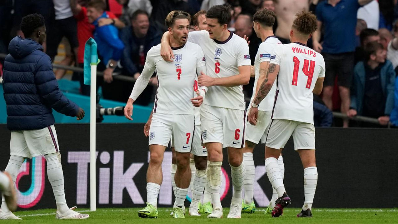 England's midfielder Jack Grealish (L) and England's defender Harry Maguire celebrate their second goal during the UEFA EURO 2020 round of 16 football match between England and Germany at Wembley Stadium in London. Credit: AFP Photo