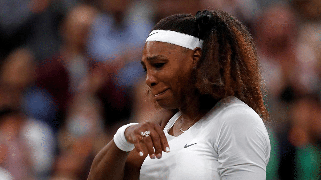 US player Serena Williams reacts as she withdraws from her women's singles first round match against Belarus's Aliaksandra Sasnovich on the second day of the 2021 Wimbledon Championships at The All England Tennis Club in Wimbledon. Credit: AFP Photo