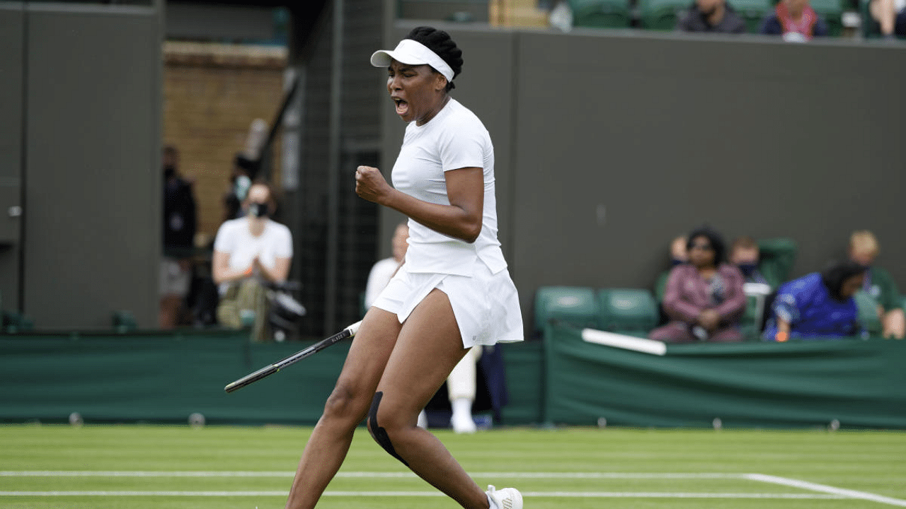 Venus Williams of the US celebrates winning the women's singles first round match against Romania's Mihaela Buzarnescu on day two of the Wimbledon Tennis Championships in London. Credit: AP Photo