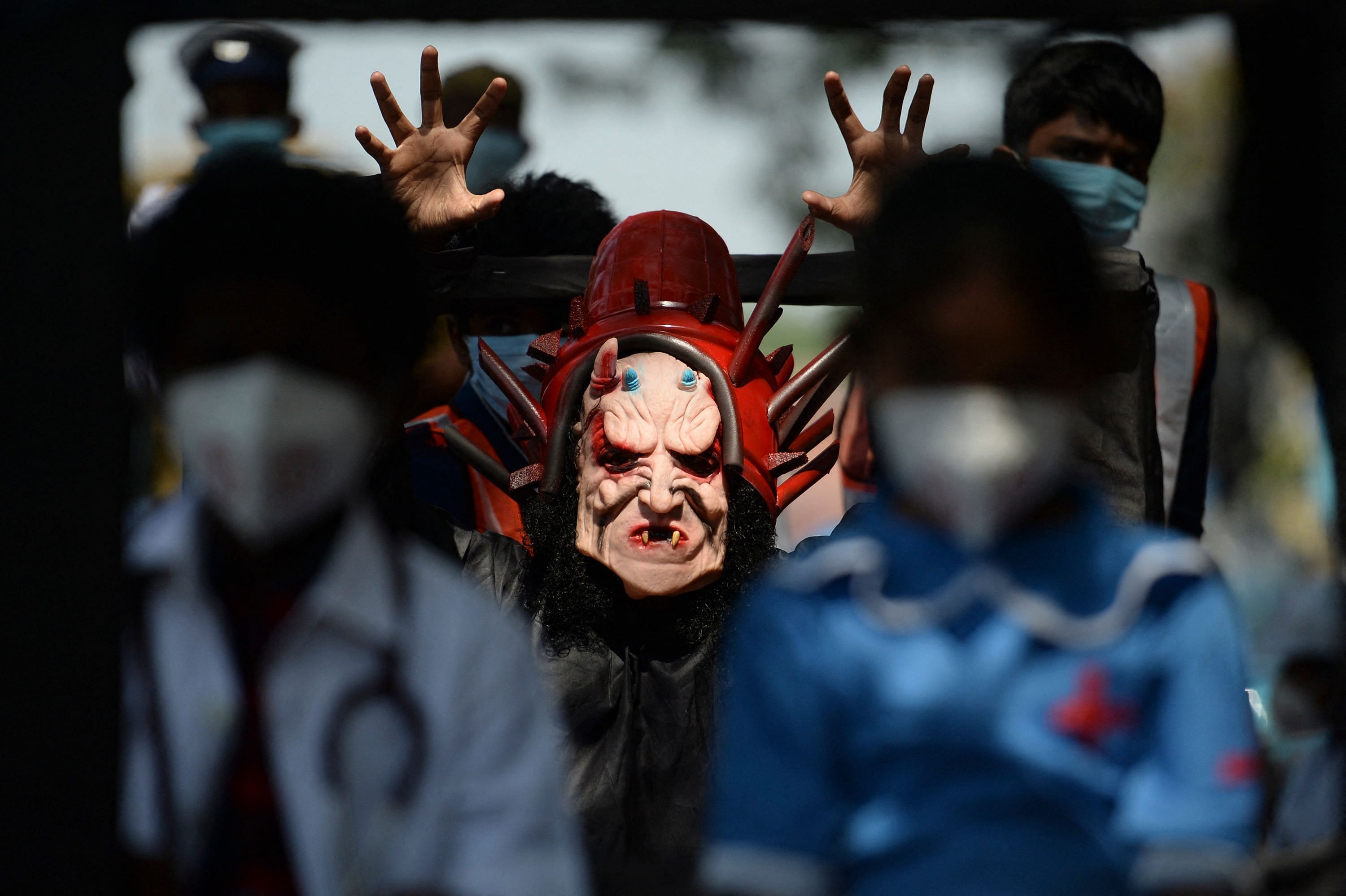 A volunteer dressed as a Coronavirus demon takes part in a Covid-19 coronavirus vaccination awareness rally in Chennai. Credit: AFP Photo