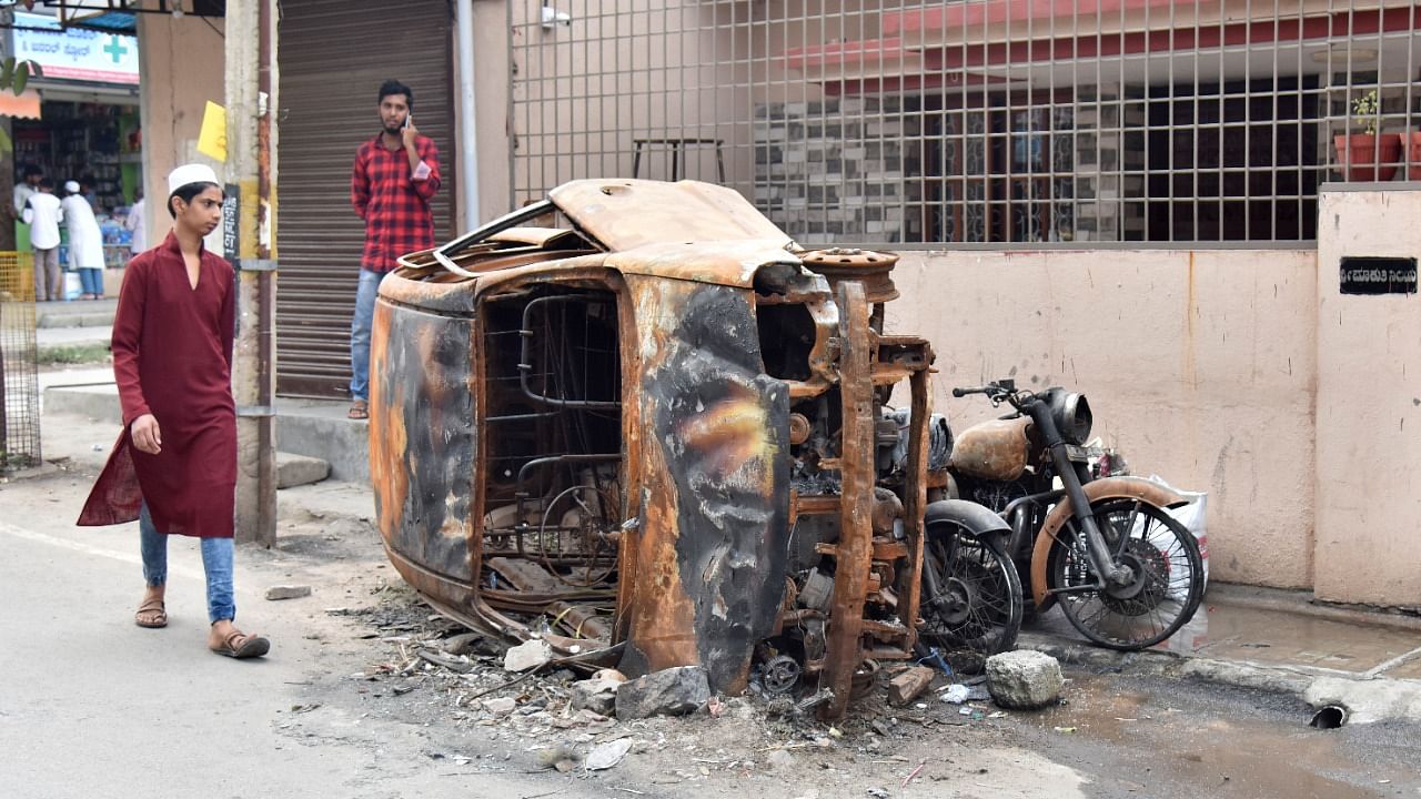 Remains of vehicles were torched during the riots that broke out after incident at KG Halli and DG Halli on August 11, 2021. Credit: DH File Photo