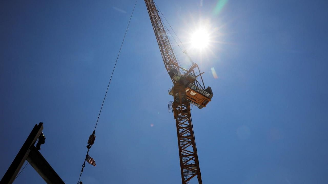 Construction workers install steel beams on high-rise building during a summer heat wave in Boston. Credit: Reuters Photo
