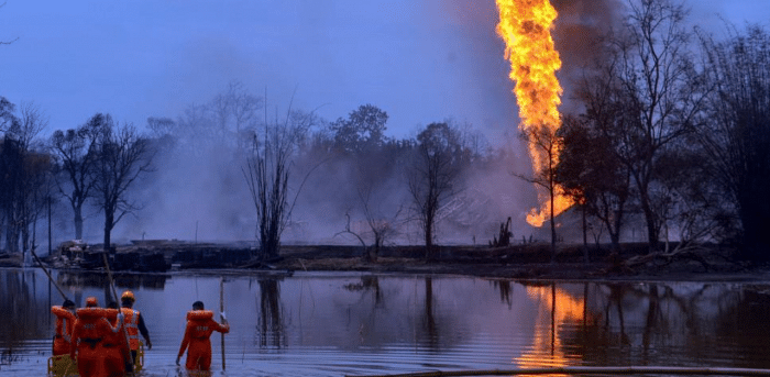 NDRF personnel search for the missing fire-fighters at a pond near an oil well as Baghjan oil field continues to burn, in Tinsukia district of Assam, Wednesday, June 10, 2020. Credit: PTI Photo