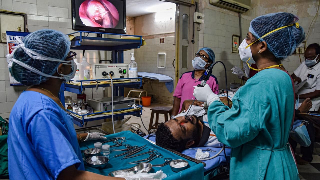 Doctors perform a diagnostic nasal endoscopy (DNE) on a patient to detect 'black fungus', at a hospital in Hyderabad, Thursday, May 20, 2021. Credit: PTI File Photo