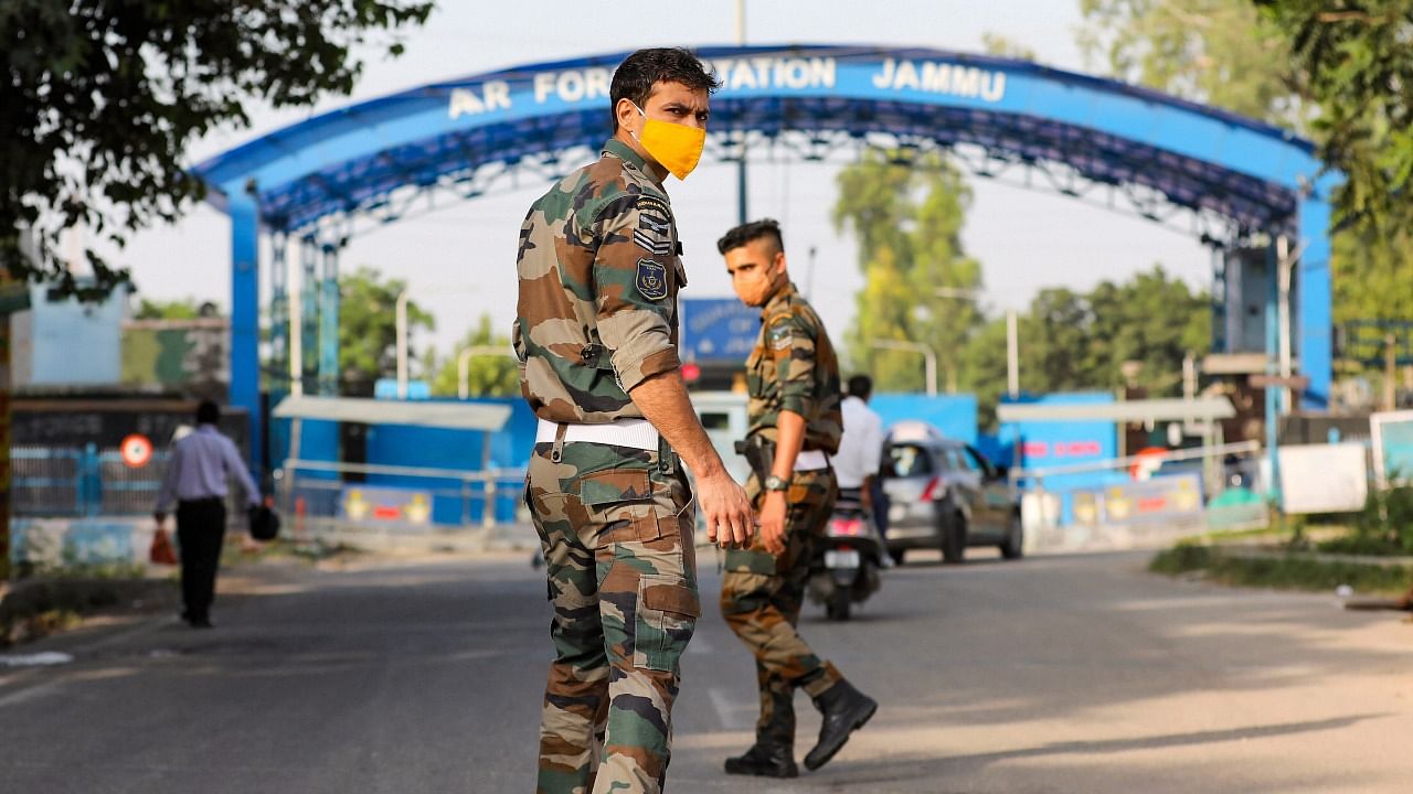 Security personnel patrol after two low intensity explosions reported in the technical area of Jammu Air Force Station in the early hours of Sunday. Credit: PTI Photo