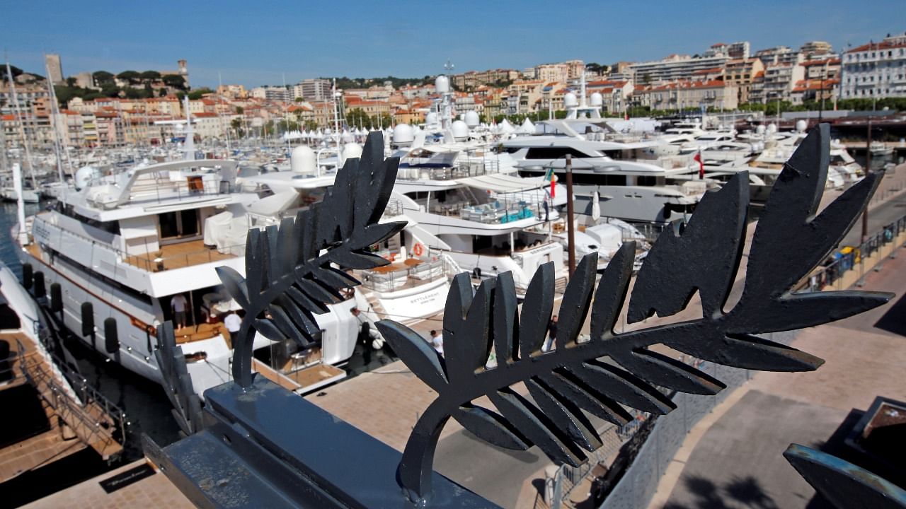 Luxury yachts are seen behind Palme d'Or symbol metal cutouts from the terrasse at the Festival Palace in Cannes. Credit: Reuters File Photo