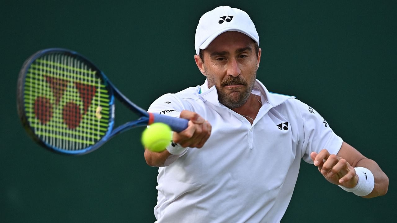 US player Steve Johnson returns to compatriot Taylor Fritz during their men's singles second round match on the fourth day of the 2021 Wimbledon Championships at The All England Tennis Club in Wimbledon, southwest London, on July 1, 2021. Credit: AFP Photo