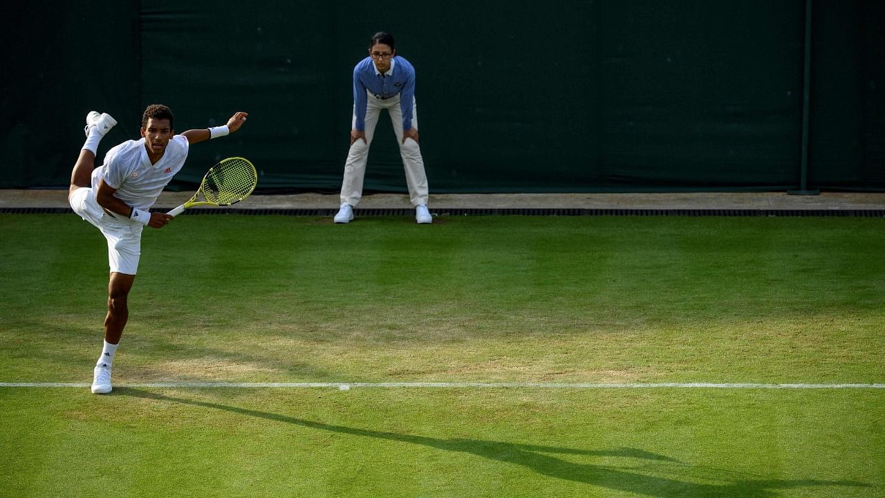 Canada's Felix Auger-Aliassime serves against Sewden's Mikael Ymer during their men's singles second round match on the fourth day of the 2021 Wimbledon Championships at The All England Tennis Club in Wimbledon, southwest London, on July 1, 2021. Credit: AFP Photo