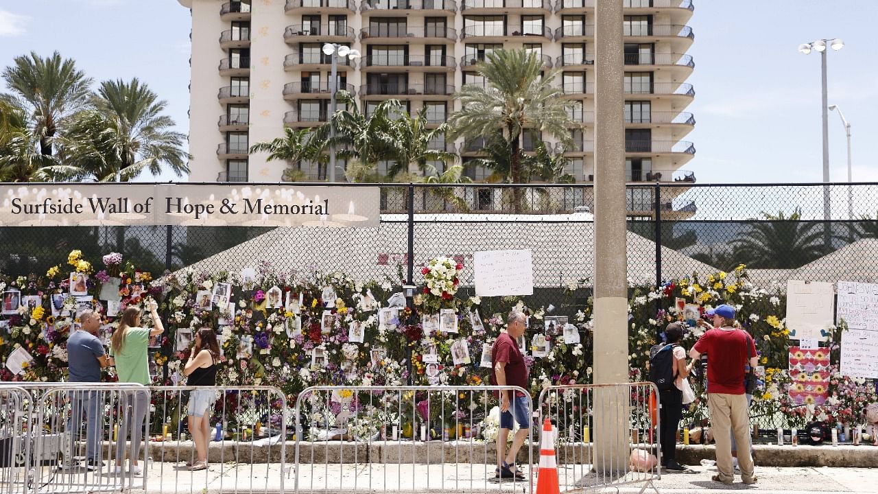 A general view of a memorial that has pictures of some of the missing from the partially collapsed 12-story Champlain Towers South condo building on July 02, 2021 in Surfside, Florida. Credit: AFP Photo