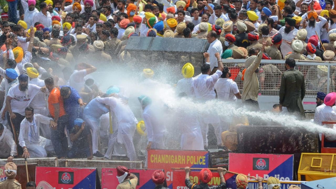 Police use water cannons to disperse the Aam Aadmi Party (AAP) workers who were staging a gherao at Chief Minister Capt Amarinder Singh’s Siswan farmhouse in protest against the long power-cuts, in Mohali, Saturday, July 3, 2021. Credit: PTI Photo