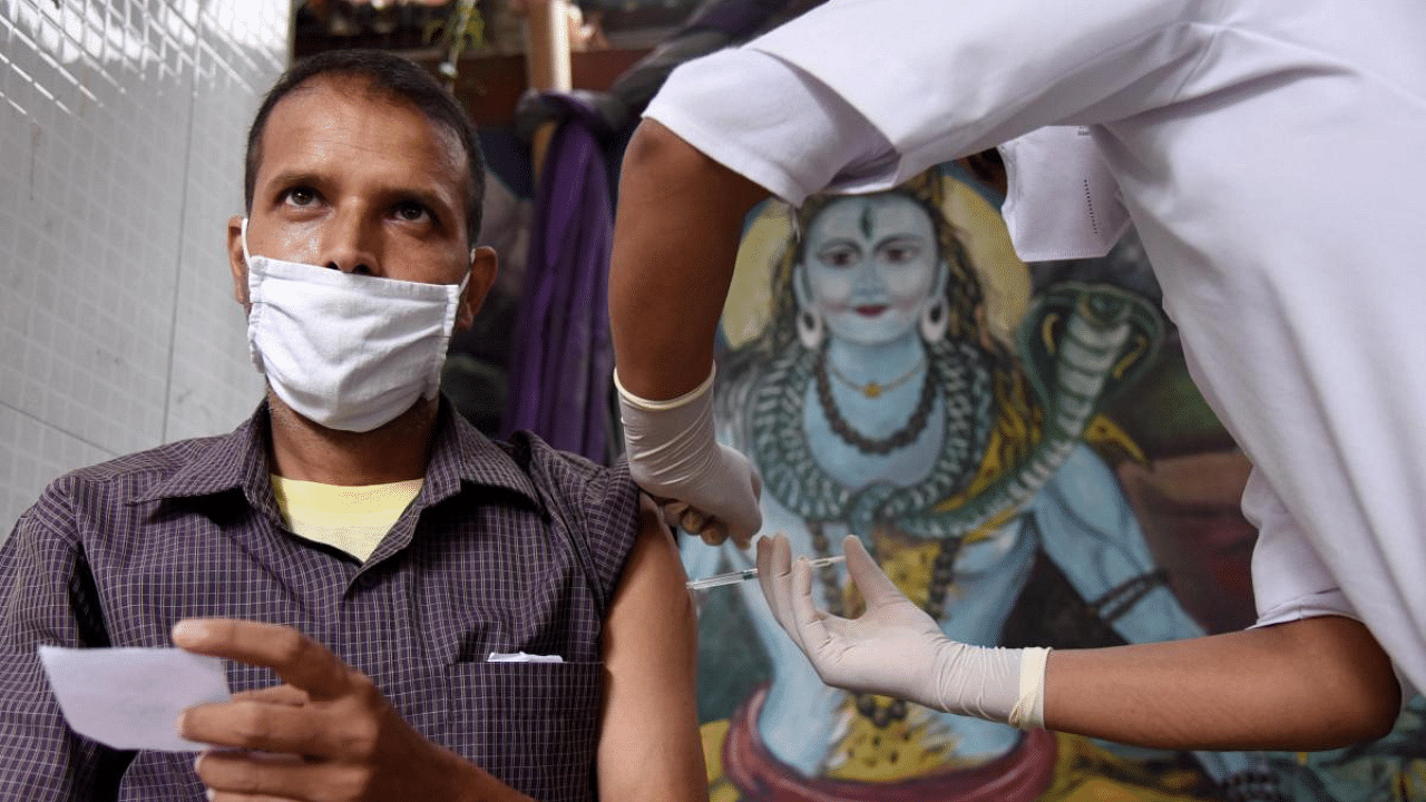 A man receives a dose of COVID-19 vaccine at a vaccination centre in Guwahati. Credit: PTI Photo