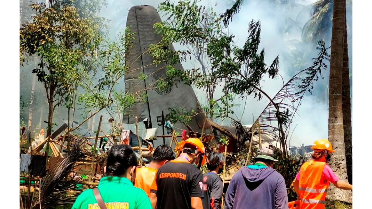 First responders work at the site after a Philippines Air Force Lockheed C-130 plane carrying troops crashed on landing in Patikul, Sulu province, Philippines. Credit: Reuters Photo