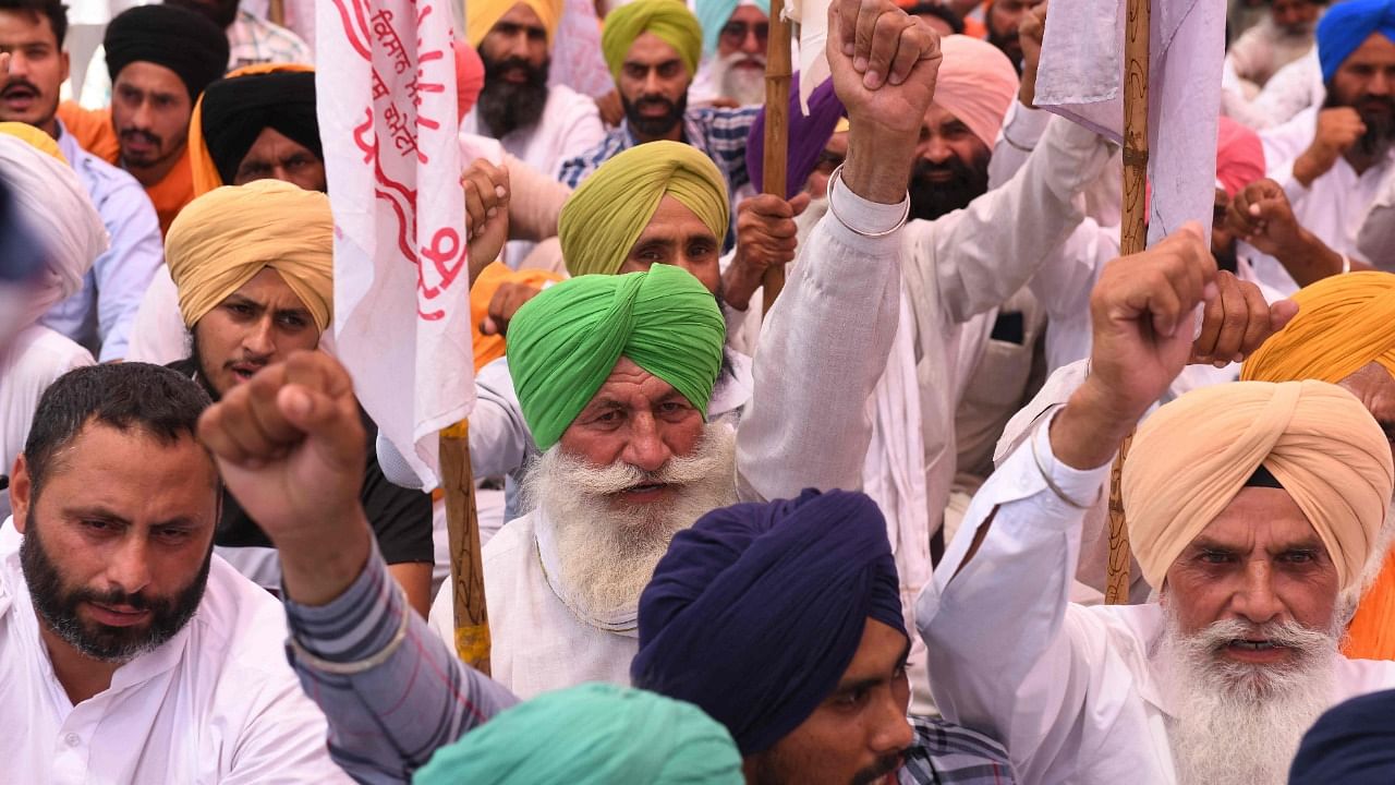 Farmers shout slogans before burning the copies of recent agricultural reforms bill during a demonstration against the central government outside the Bharatiya Janata Party (BJP) office in Amritsar on June 5, 2021. Credit: AFP Photo
