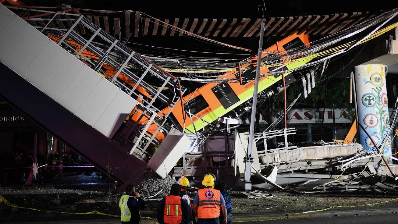Rescue workers gather at the site of a train accident after an elevated metro line collapsed in Mexico City. Credit: AFP File Photo