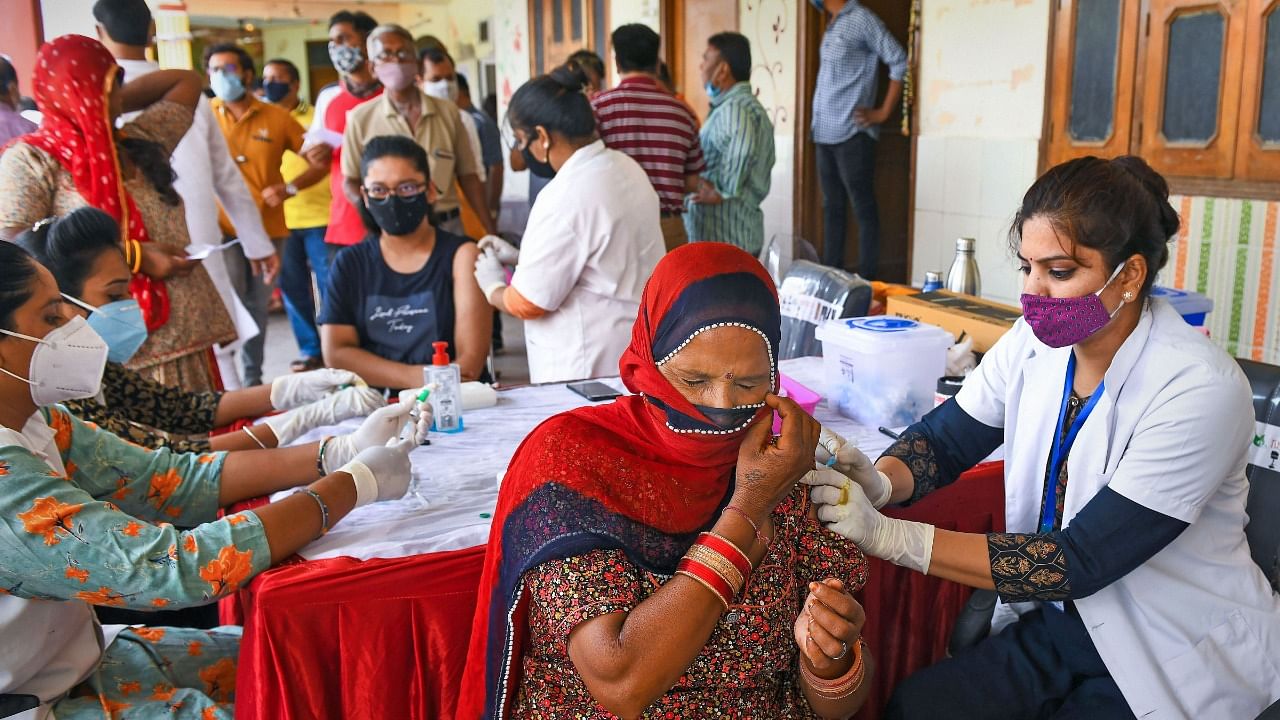 Health workers administer a dose of Covid-19 vaccine to beneficiaries during a special one-day vaccination drive at a vaccination center in Beawar, Sunday, June 27, 2021. Credit: PTI Photo