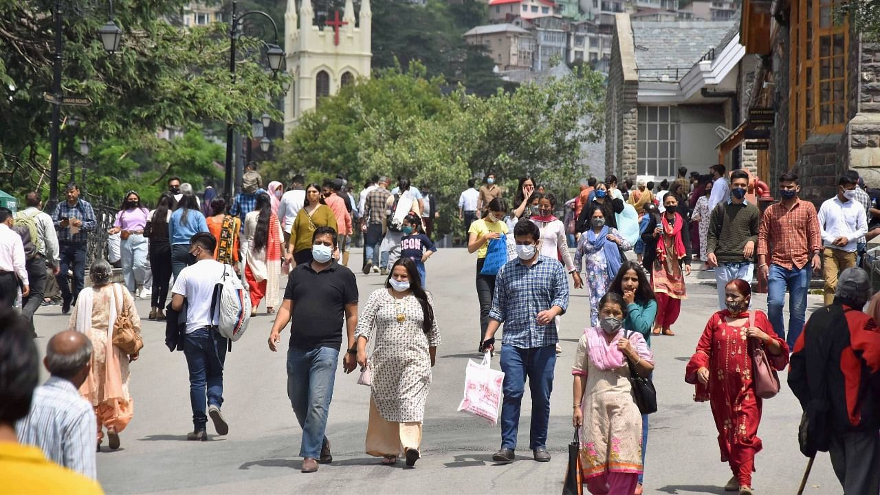 Tourists and locals walk on the Ridge Road following ease in Covid-induced restrictions in Shimla. Credit: PTI Photo