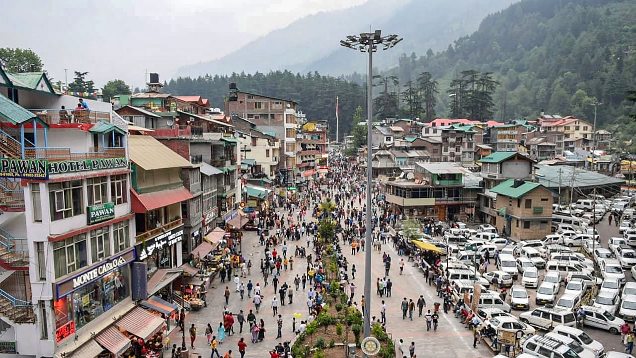Tourists visit the Mall Road after relaxation in Covid-19 curfew, in Manali. Credit: PTI Photo