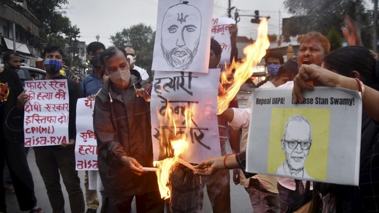 Activists participate in candle light vigil to pay tribute to civil rights activist Father Stan Swami, an accused in the Elgar Parishad-Maoist links case who died at a Mumbai hospital, in Ranchi. Credit: PTI Photo