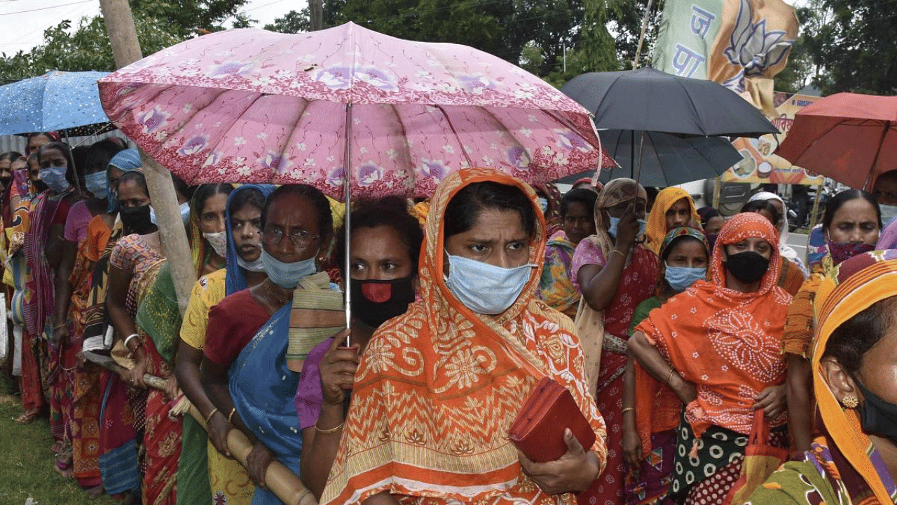 Needy people wait in queues to receive free food packages under 'Chief Minister Covid Special Relief Package Scheme', in Agartala. Credit: PTI Photo