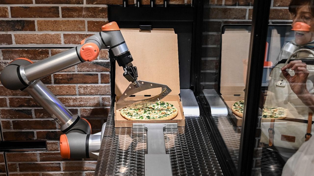 "Pazzi", a pizza-making robot at work in a restaurant in Paris. Credit: AFP Photo
