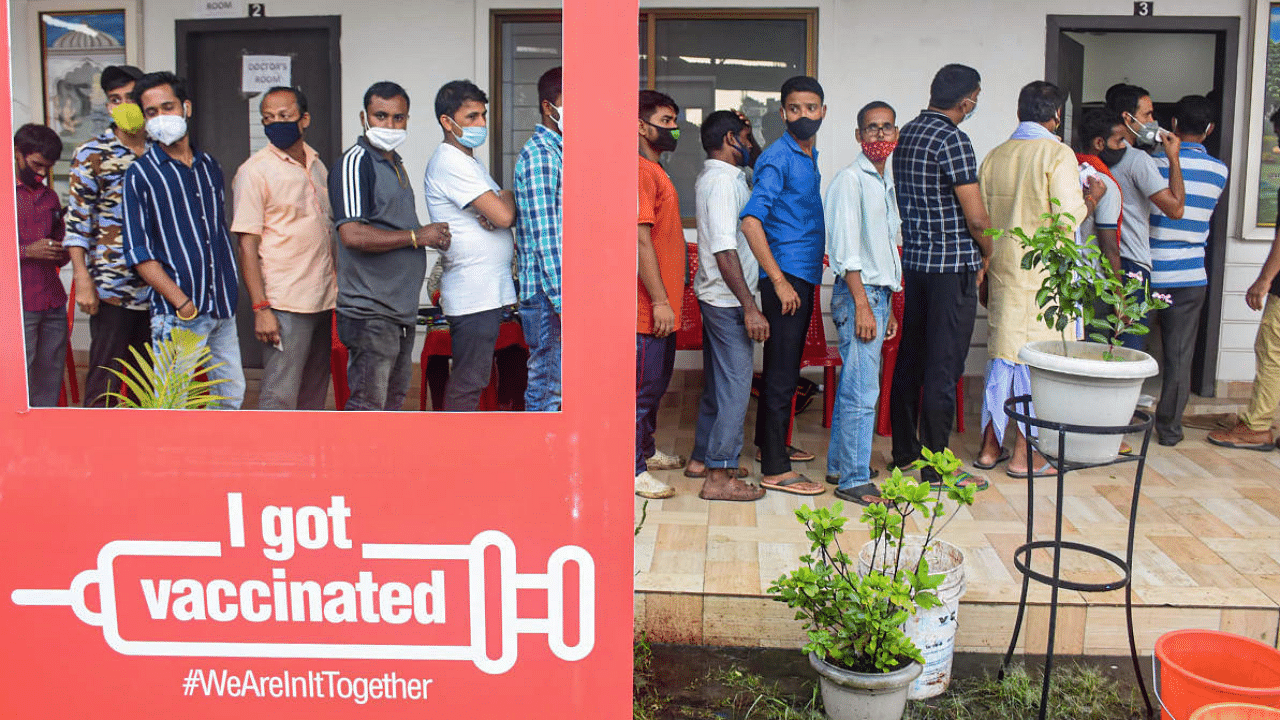 Beneficiaries wait in a queue to receive Covid-19 vaccine dose, at a vaccination centre, in Guwahati. Credit: PTI Photo