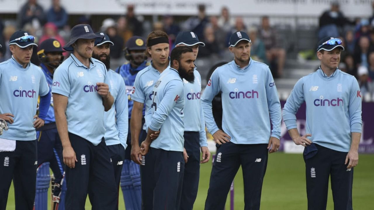 England's captain Eoin Morgan (right) and teammates during the third one day international cricket match between England and Sri Lanka, at Bristol County Ground in Bristol, England, Sunday, July 4, 2021. Credit: PTI Photo