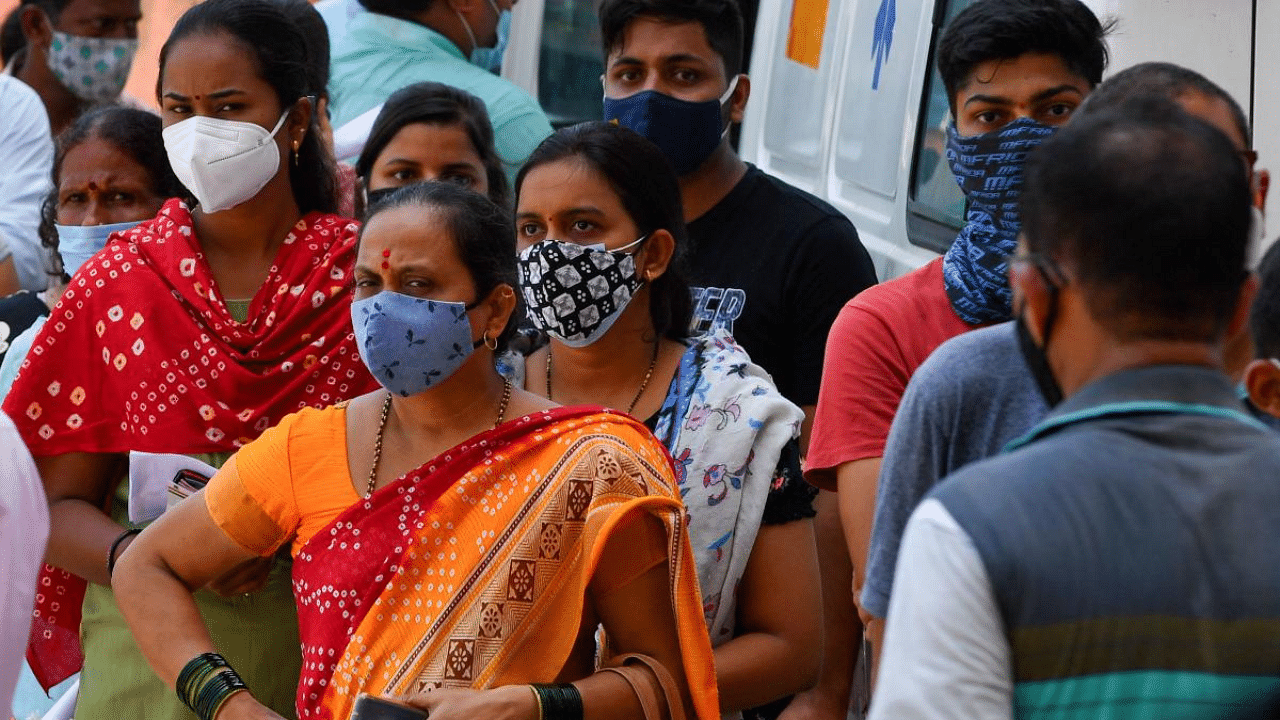 Residents wait to get themselves inoculated in Mumbai. Credit: AFP Photo