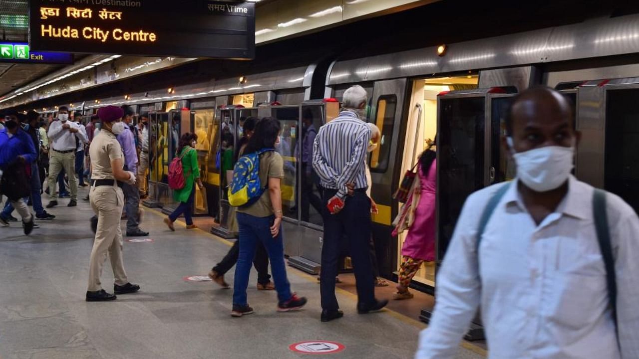 Passengers board a metro train at Kashmere Gate Metro Station in New Delhi. Credit: PTI Photo