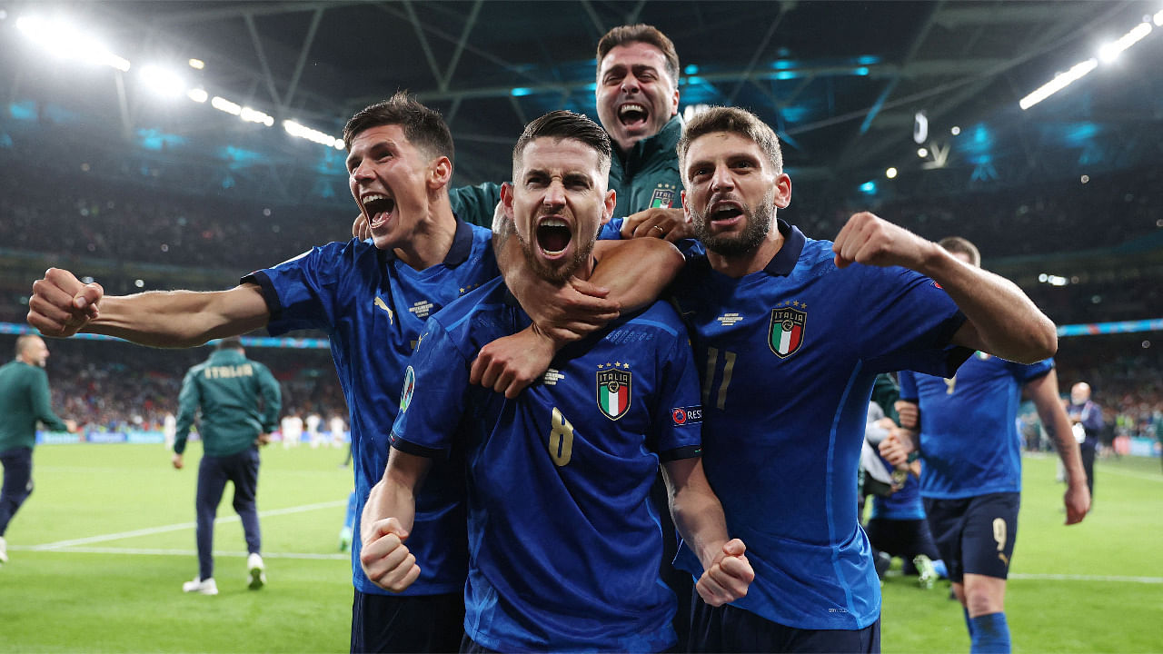  Italy's midfielder Jorginho (C) celebrates with teammates after scoring in a penalty shootout and winning the UEFA EURO 2020 semi-final football match between Italy and Spain at Wembley Stadium. Credit: AFP Photo