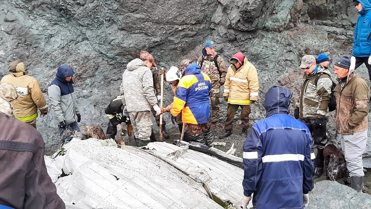 This photo released by the Russia Emergency Situations Ministry press service on Wednesday, July 7, 2021, shows Emergency Situations Ministry workers at the wreckage of a missing Antonov An-26 missing plane found near its destination airport outside the town of Palana, in Russia's Far East. Authorities in Russia say rescuers have found the bodies of nine victims a day after a plane crash in a remote area in the country's Far East. Credit: AP/PTI file photo