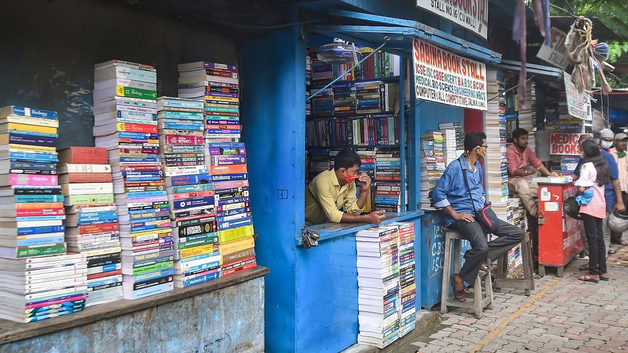 Shopkeepers wait for customer at a book market in college street area after authority eased some restrictions during Covid induced lockdown in Kolkata. Credit: PTI Photo