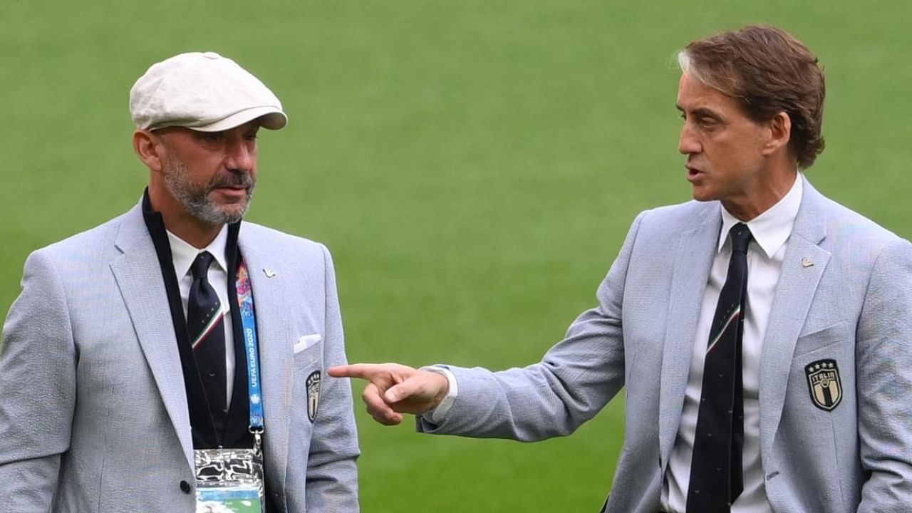 Italy's coach Roberto Mancini (R) talks with national team staff member Gianluca Vialli (L) Credit: AFP Photo