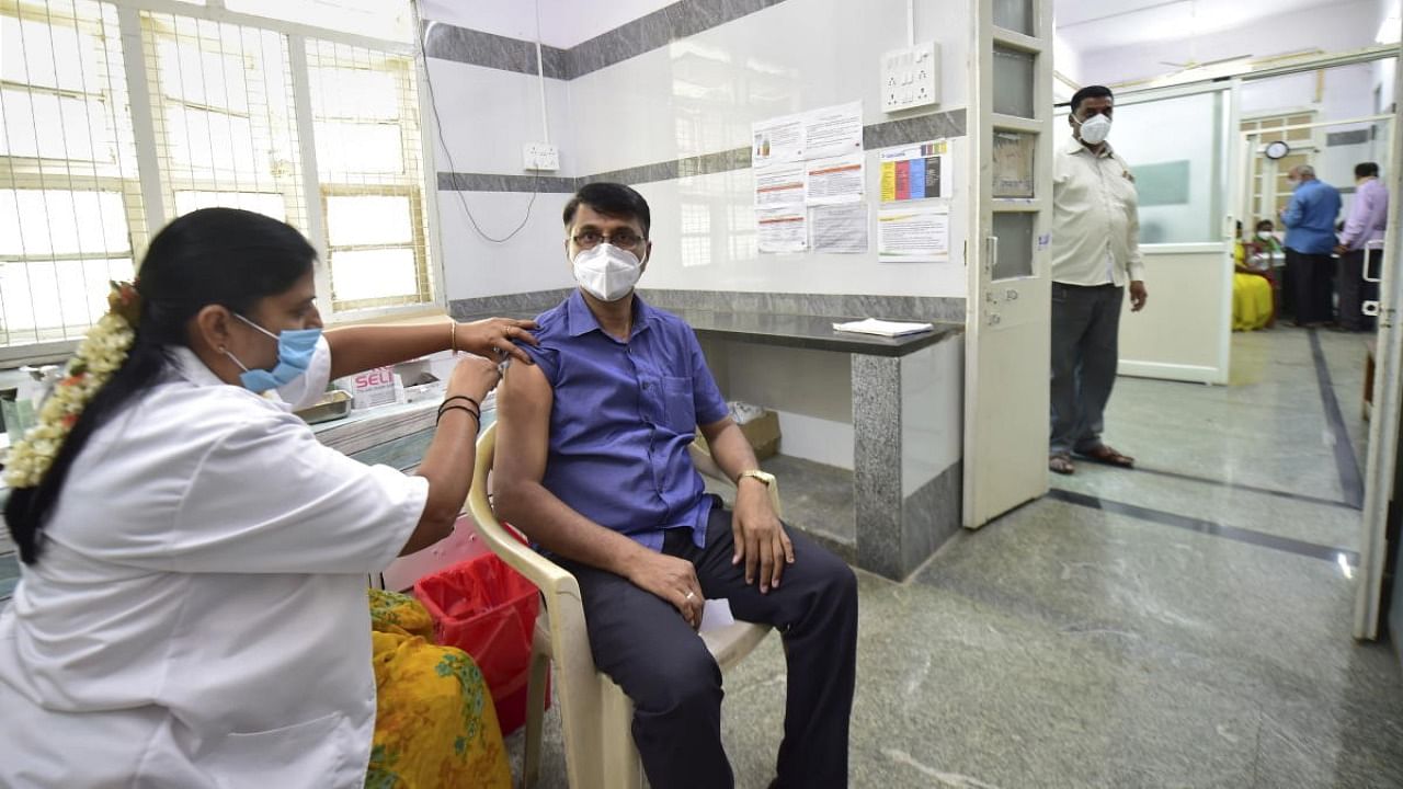 A medic administers the second dose of Covid-19 vaccine to a beneficiary at a hospital in Bengaluru. Credit: PTI Photo