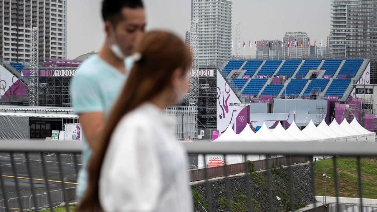 People walk past the Ariake Urban Sports Park, the main venue for cycling BMX freestyle, cycling BMX racing and skateboarding events at the Tokyo 2020 Olympic Games, two weeks prior to the start of the games in Tokyo. Credit: AFP Photo