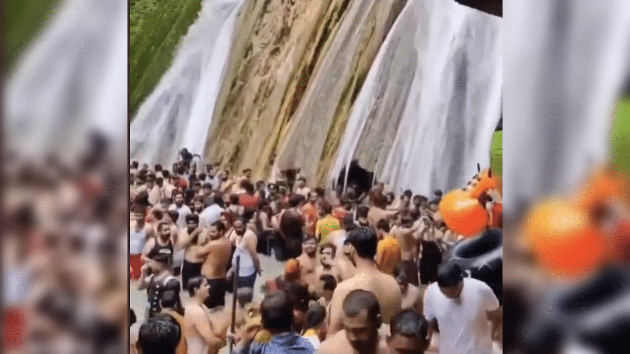This picture had gone viral on Thursday showing several tourists in close proximity without face masks at Kempty falls, Mussorie. Credit: ANI Photo