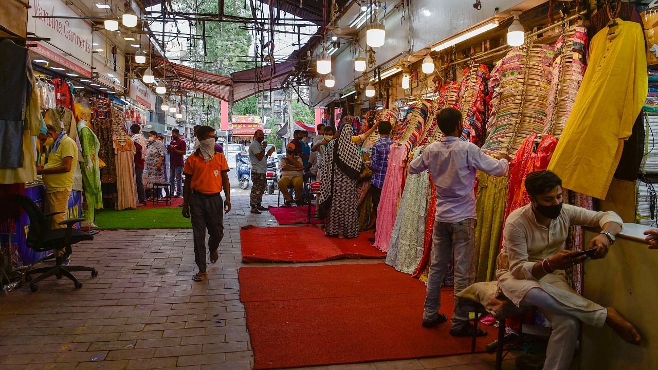 People shop at Lajpat Nagar Central Market after it reopened on Wednesday, July 7, 2021. Credit: PTI Photo